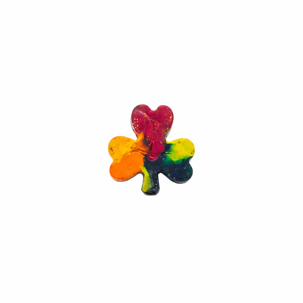 A swirly shamrock-shaped crayon in rainbow colors on a pure white background