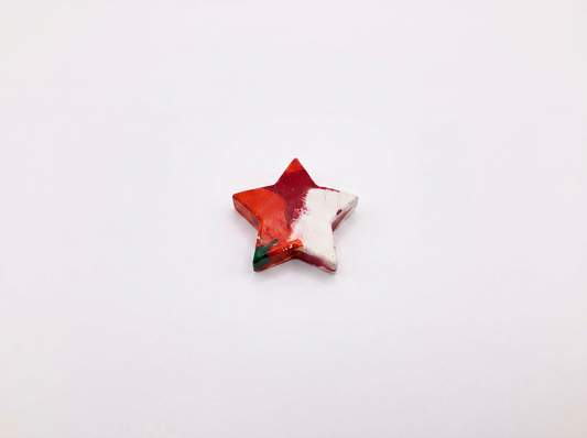 Handmade star-shaped Waxadoodle crayon with swirled colors