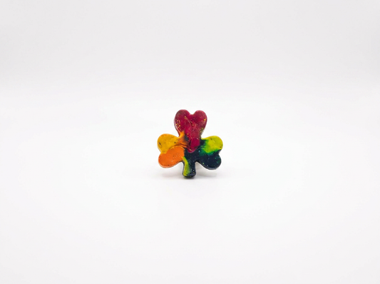 Handmade shamrock-shaped Waxadoodle crayon with red, orange, yellow and green swirls